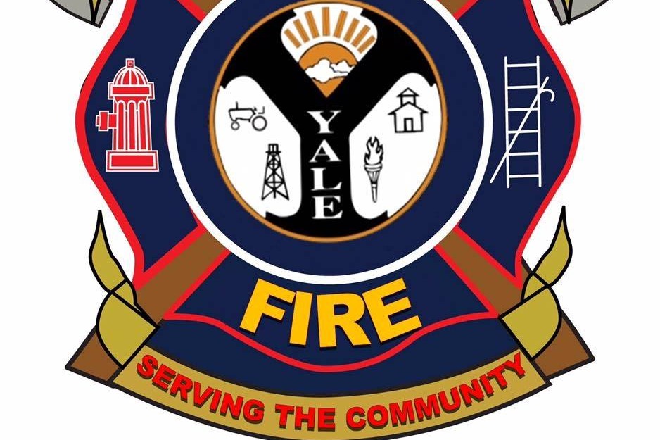 city of yale fire department seal image with fire and Serving the community on it.