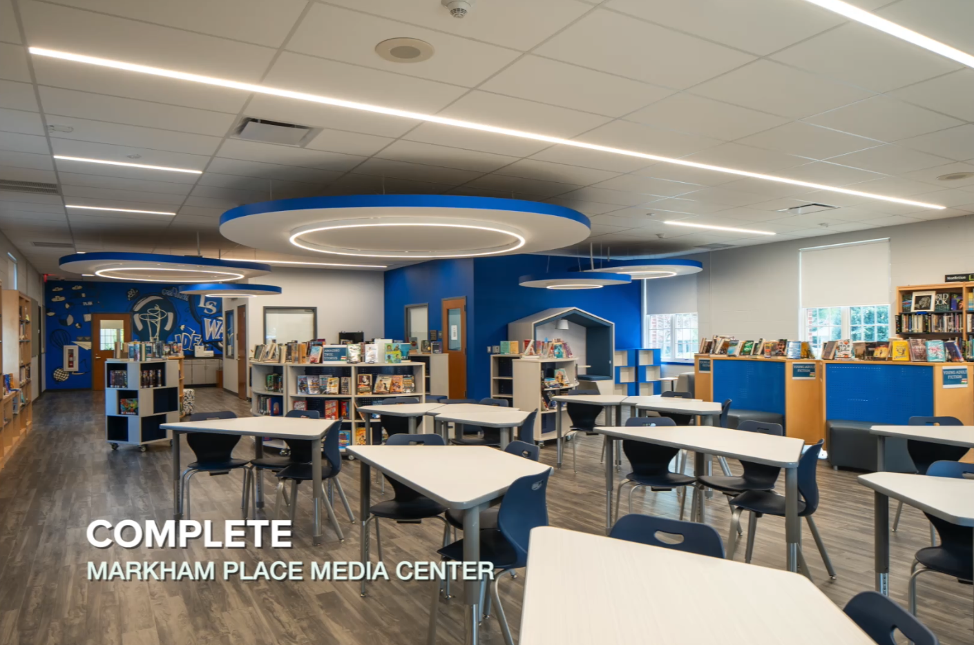 Markham media center with book shelves, desks, and hanging lights