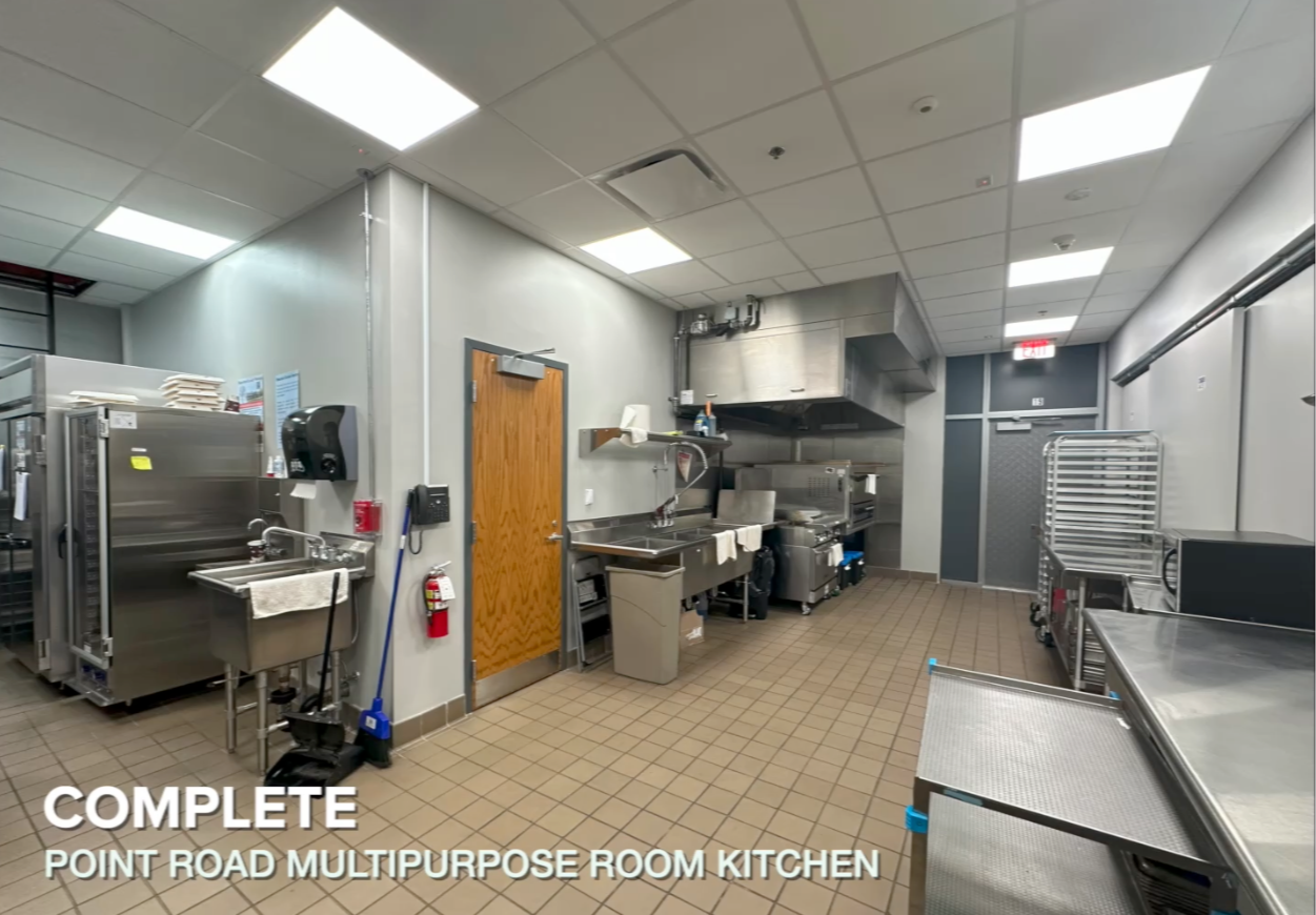 overview of kitchen with pizza oven and steel countertops