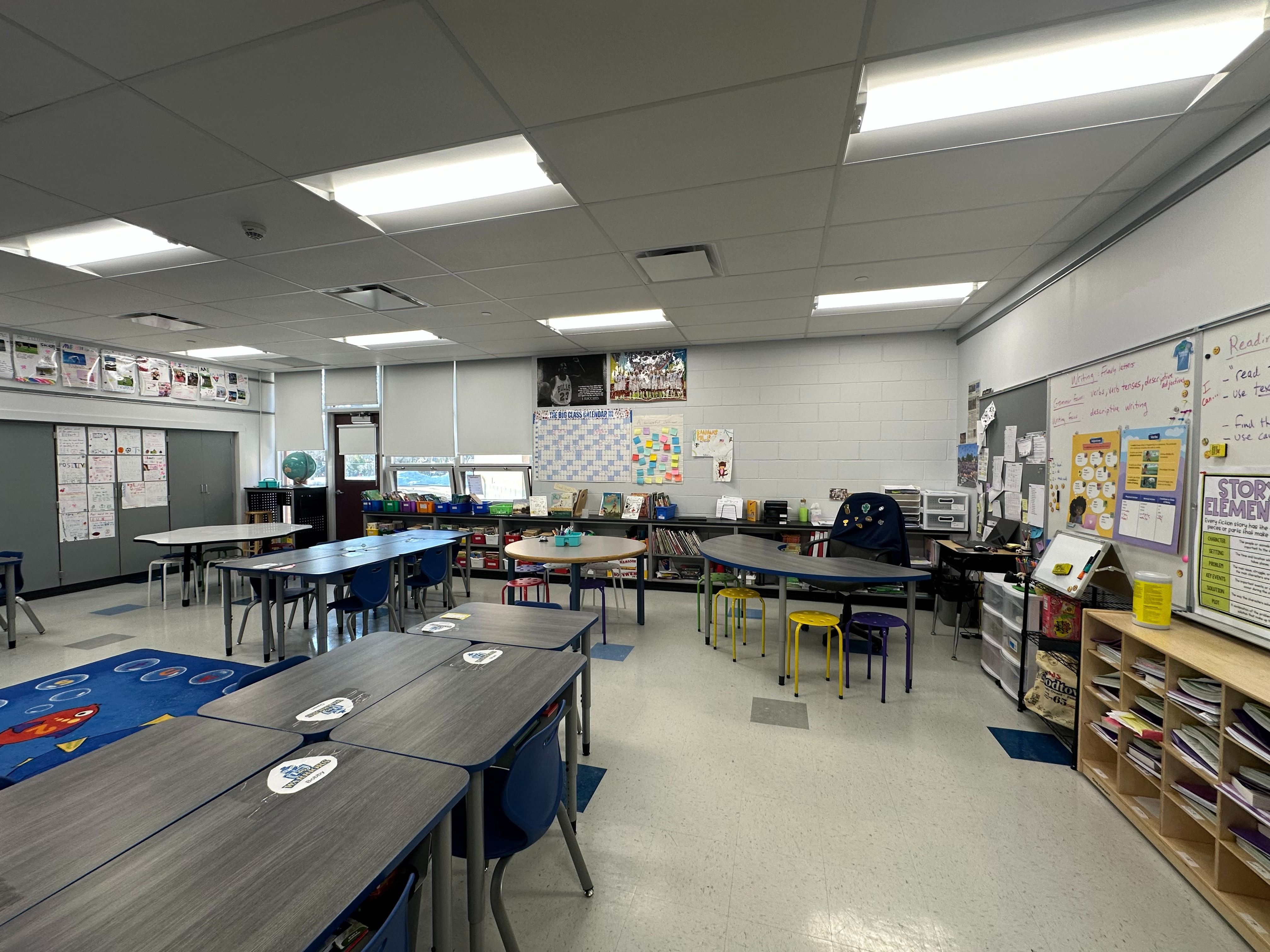 classroom with desks and chairs and bookshelves