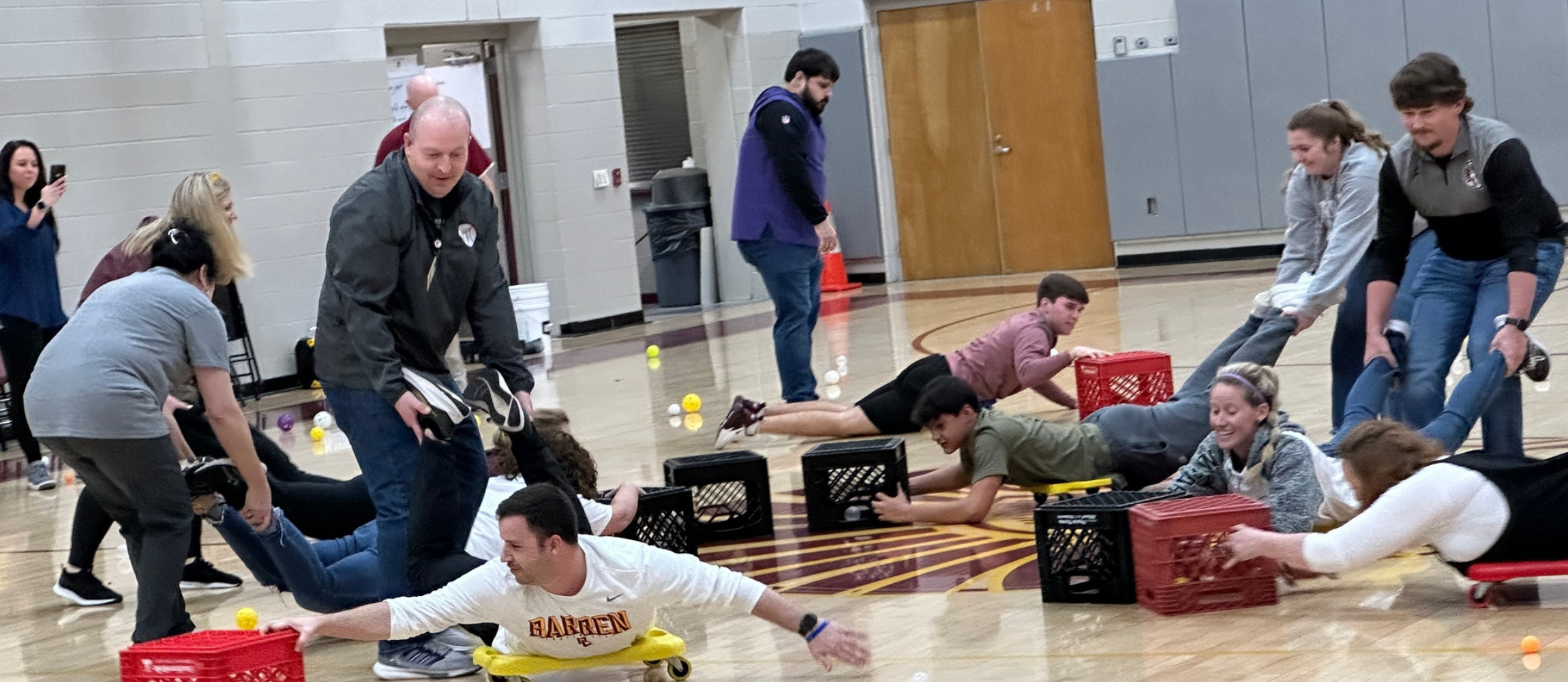 Students and teachers playing in gym