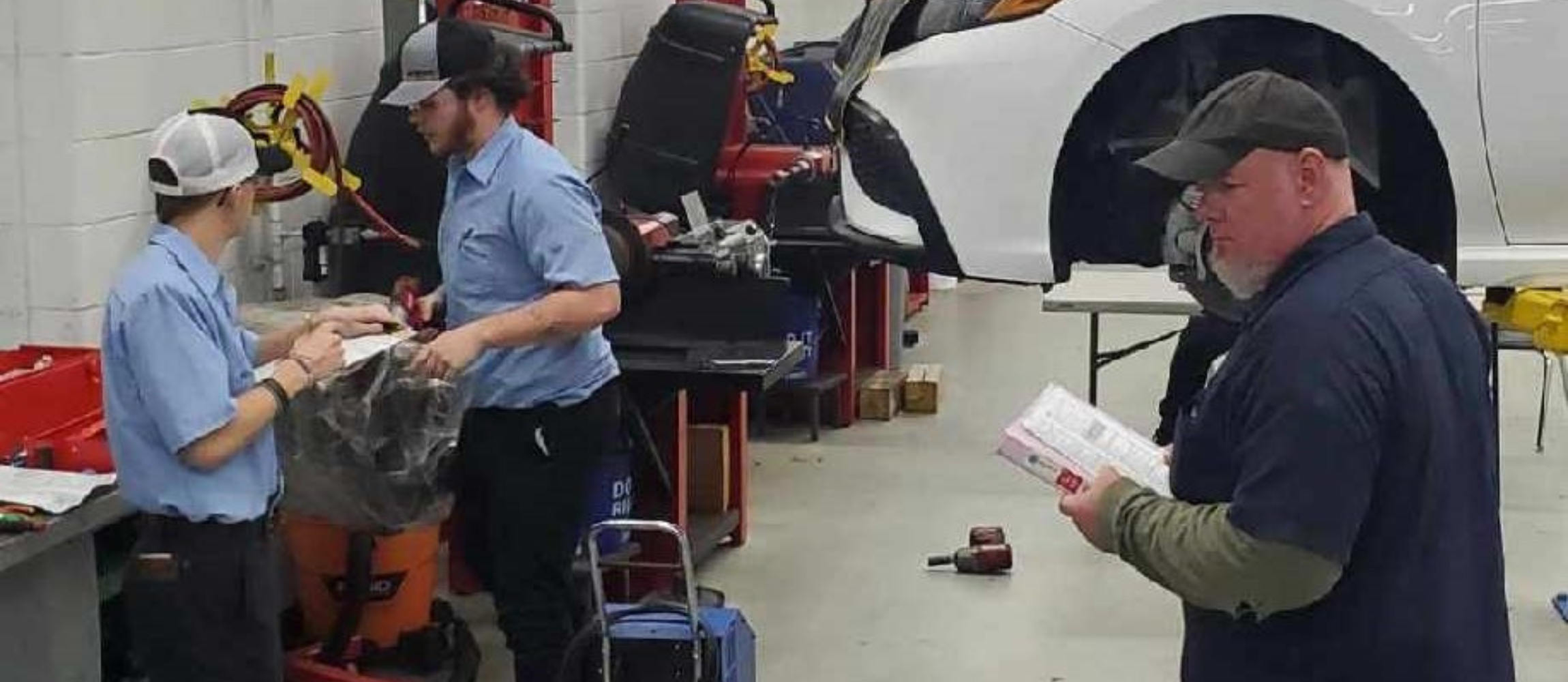 Students and teacher in automotive class