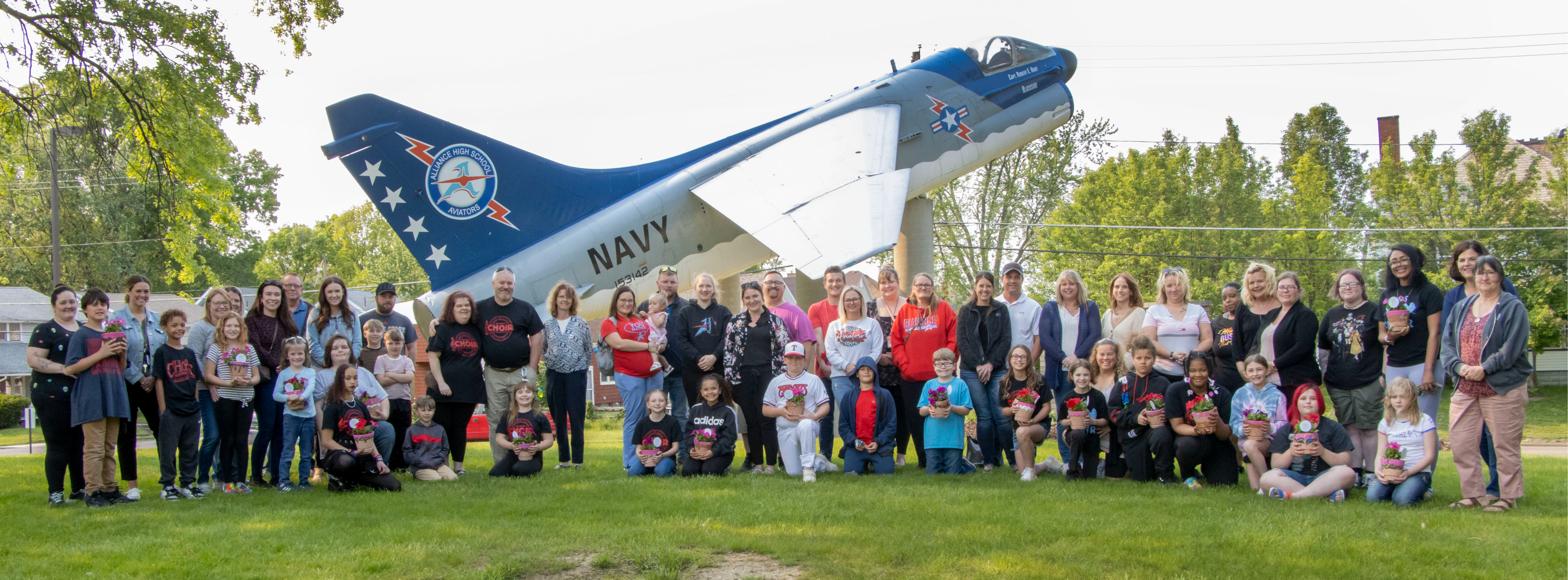 AIS families in front of the Jet at AHS