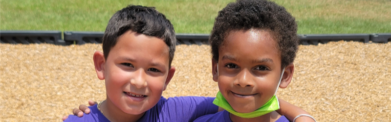 two students standing together on field day