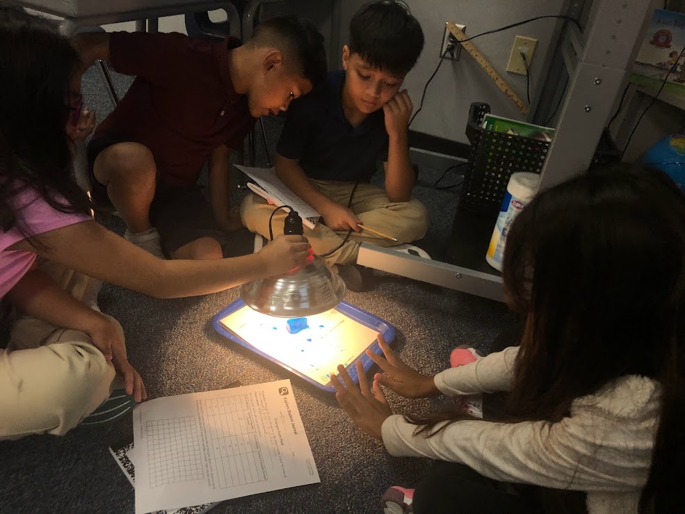students exploring light melting