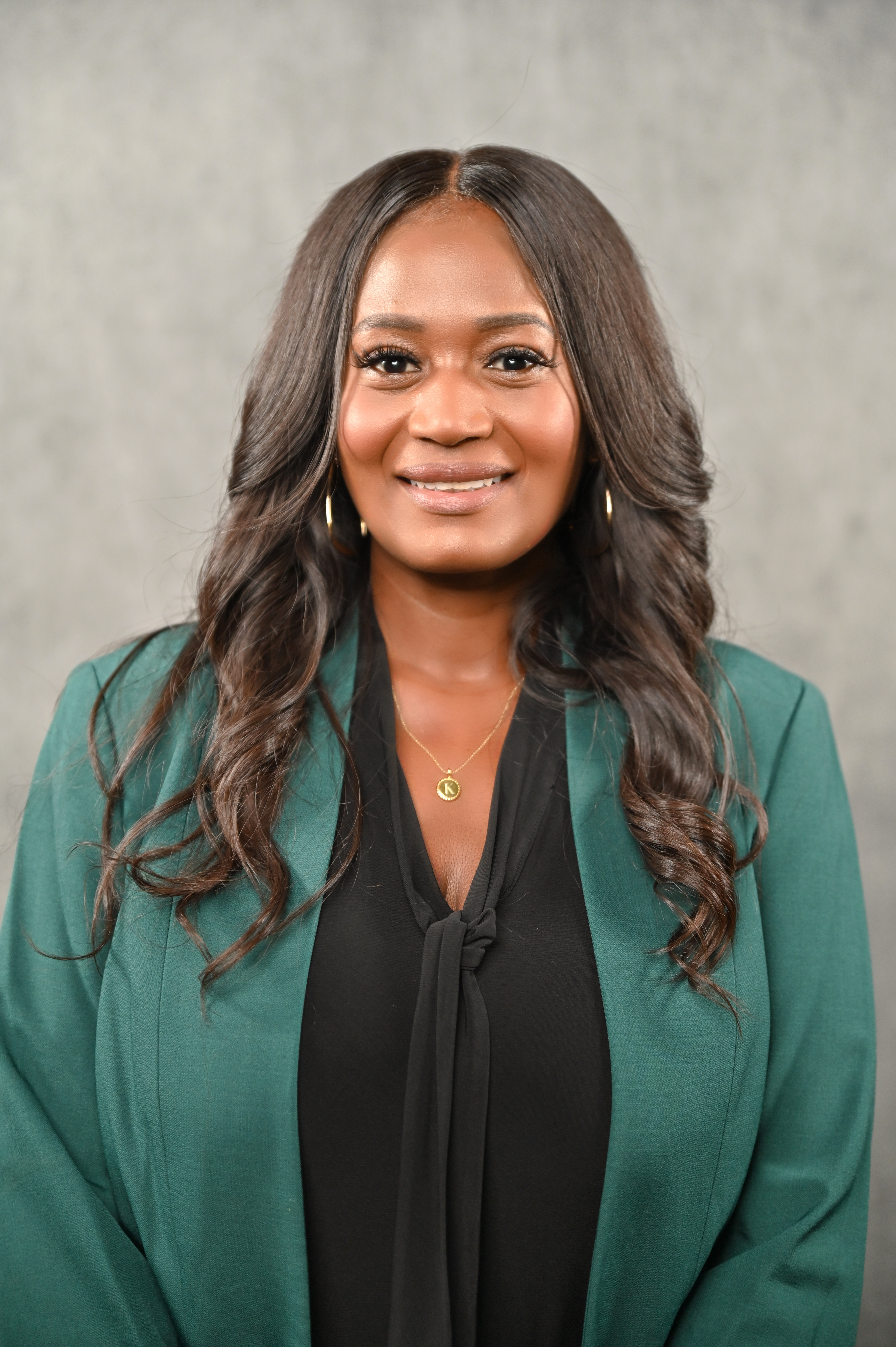 Ms. Kimberly Toney - smiling black woman with green blazer, black shirt