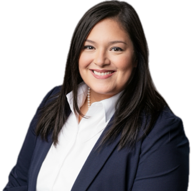 A woman in a navy blazer over a white shirt stands with a smile. She has long black hair and a pearl necklace.