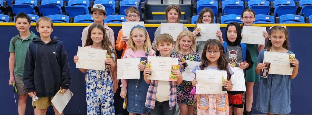 14 students who won the March Good Character Award for each classroom in grades Kindergarten through 6 grade pose for a photo.