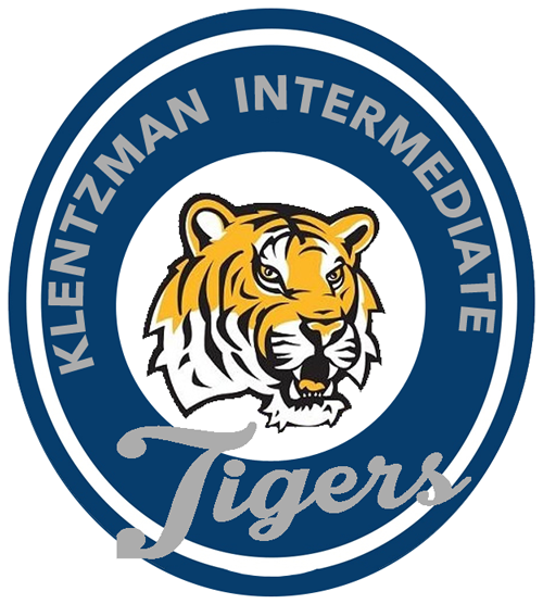 Blue and white circular logo for Klenzman Intermediate Tigers. The logo features a stylized tiger's head in orange and white.