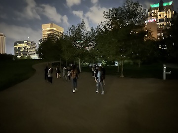 Team members walking through a park at night