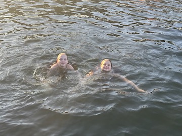 two girls swimming in the lake