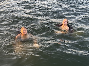 two other girls swimming in the lake