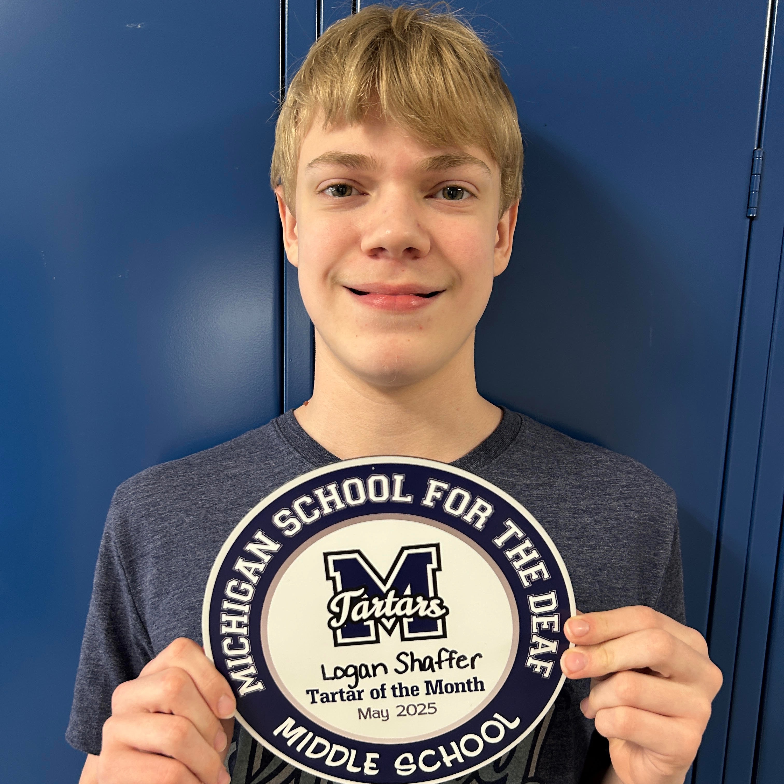 Logan Schaffer holding a plaque