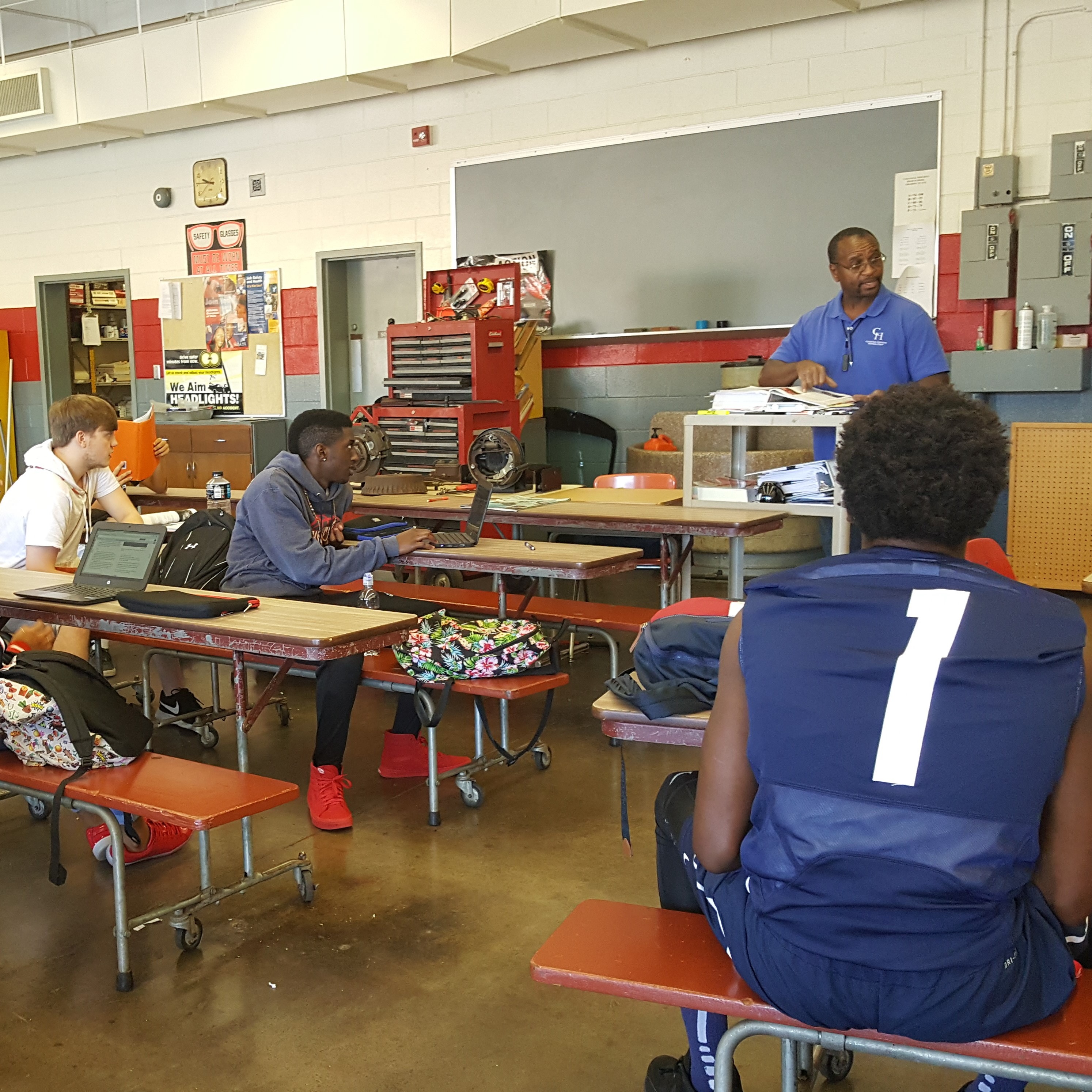 teacher teaching and explaining to the students