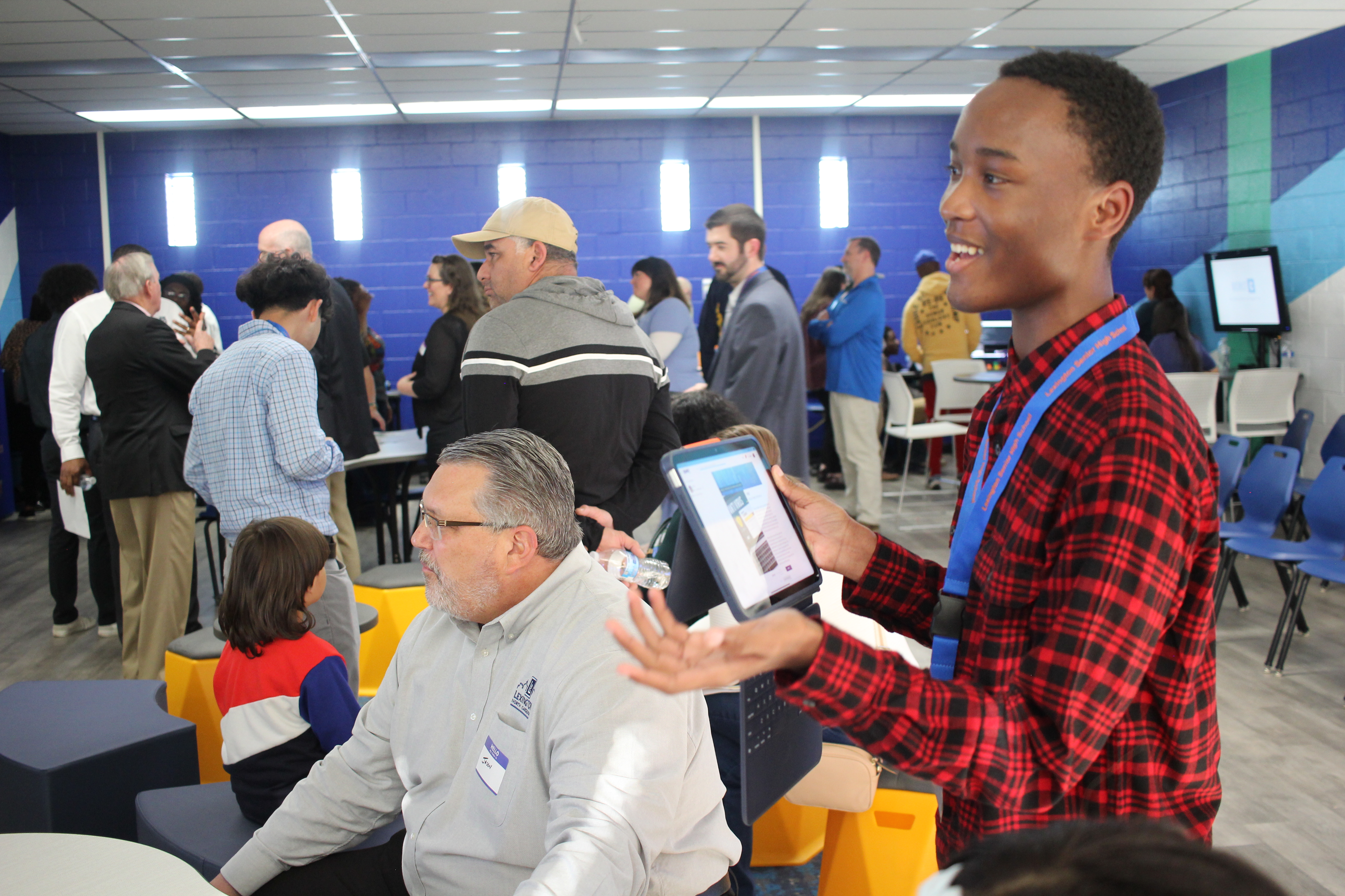 Keith Hill shares one of his SparkNC Unit Final projects with Mayor Jason Hayes and other local business leaders!