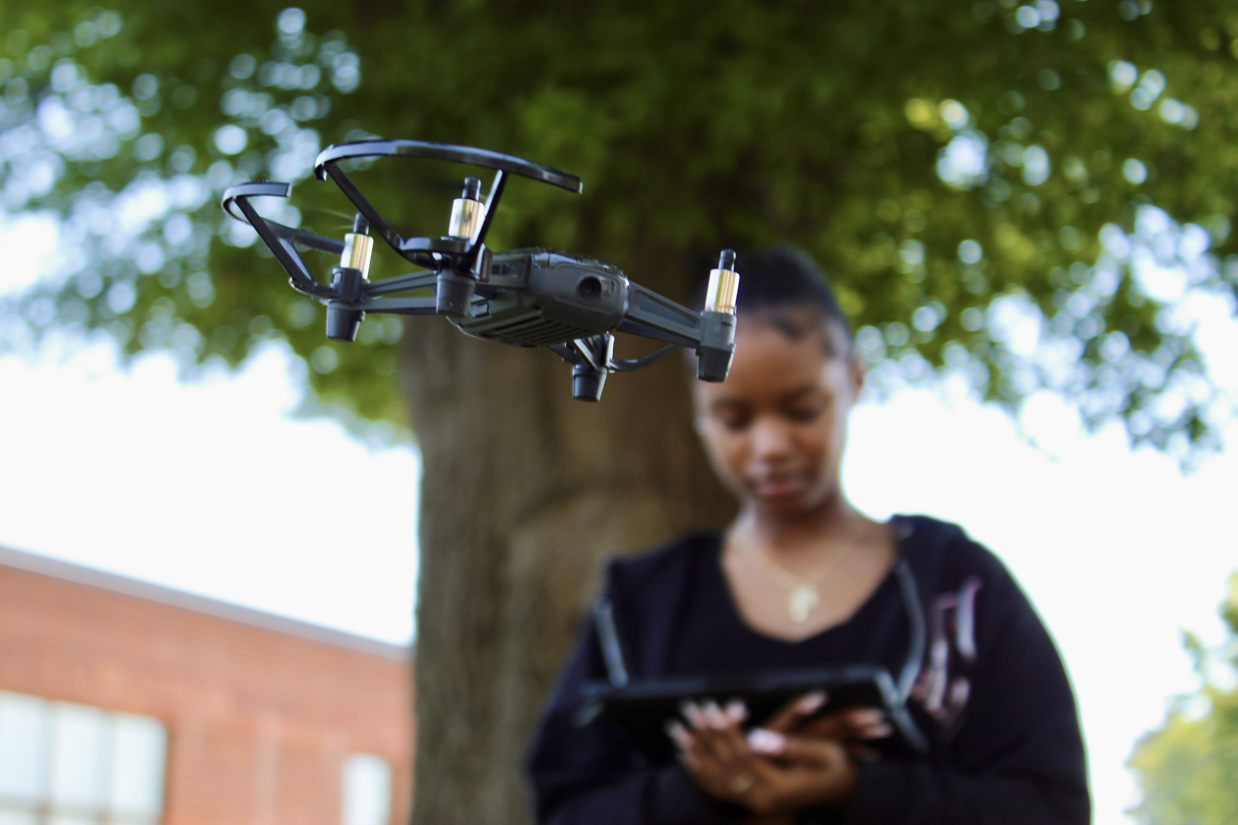 Student Zymorra Curlee flies a drone outside of the Sparklab!