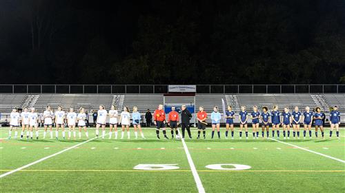 2 soccer teams standing on the field