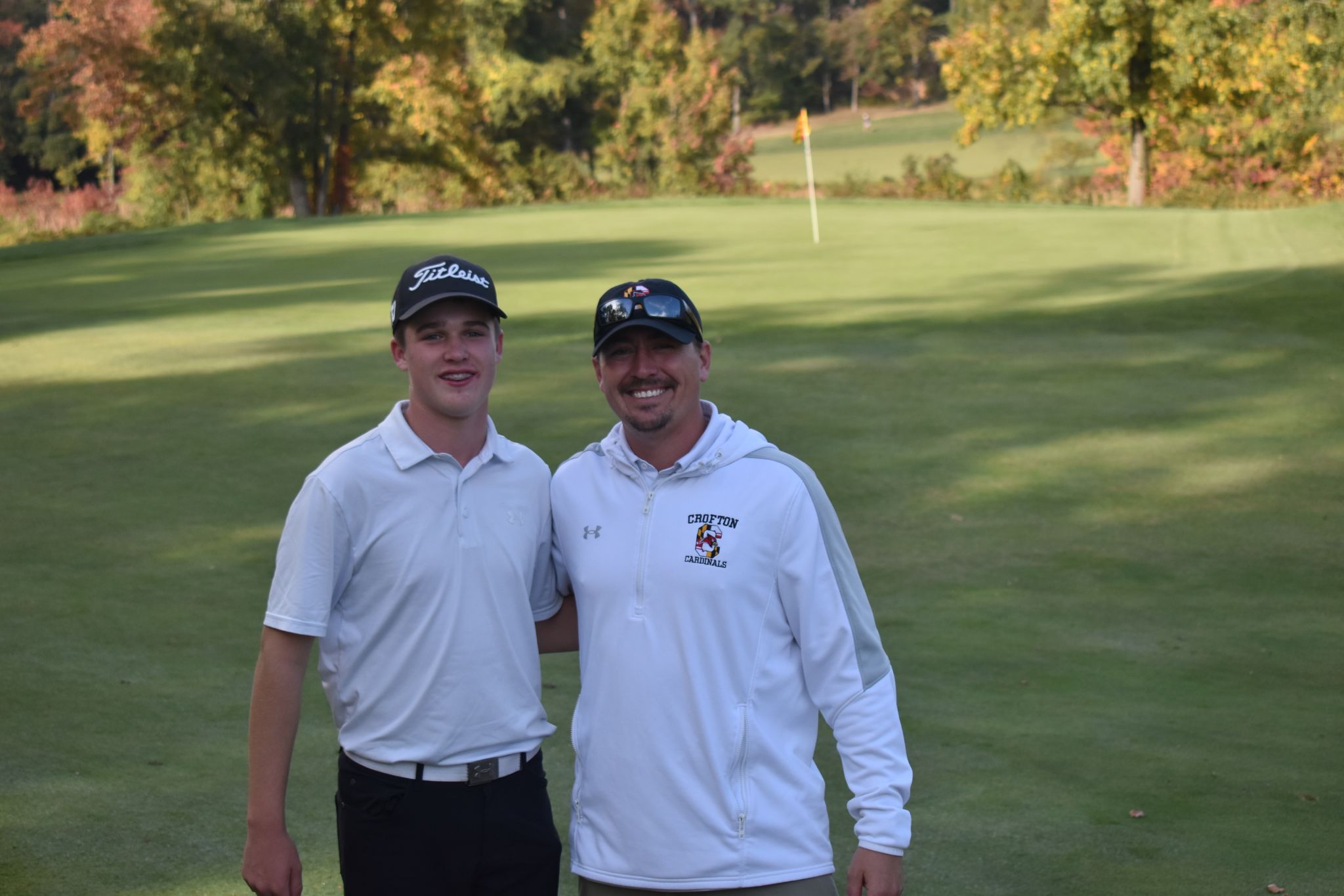 2 golf player hugging each other