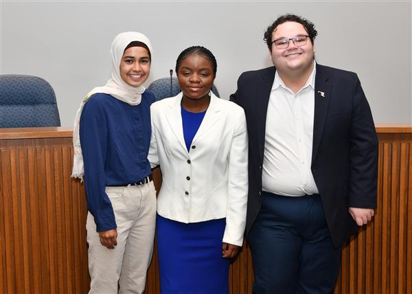 3 people standing and smiling