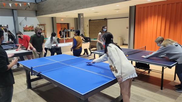 people gathered playing ping pong