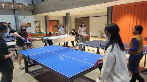 people gathered playing ping pong