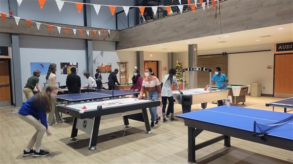 people gathered playing ping pong