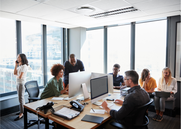 Stock photo of people working in corner office