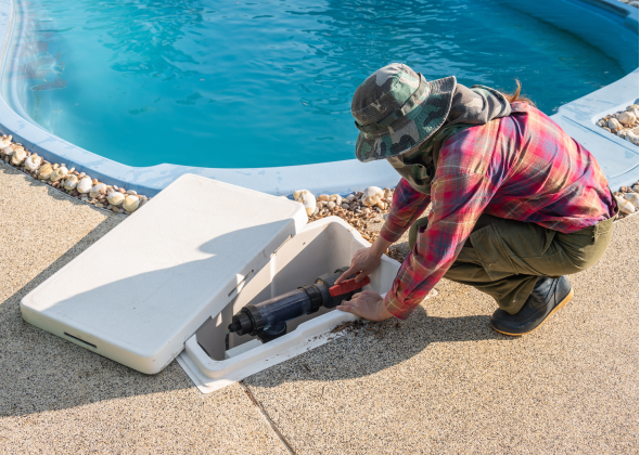 Plumber checking pool's filter