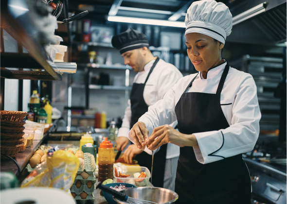 Chefs preparing dish