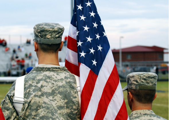 Soldiers standing with american flag