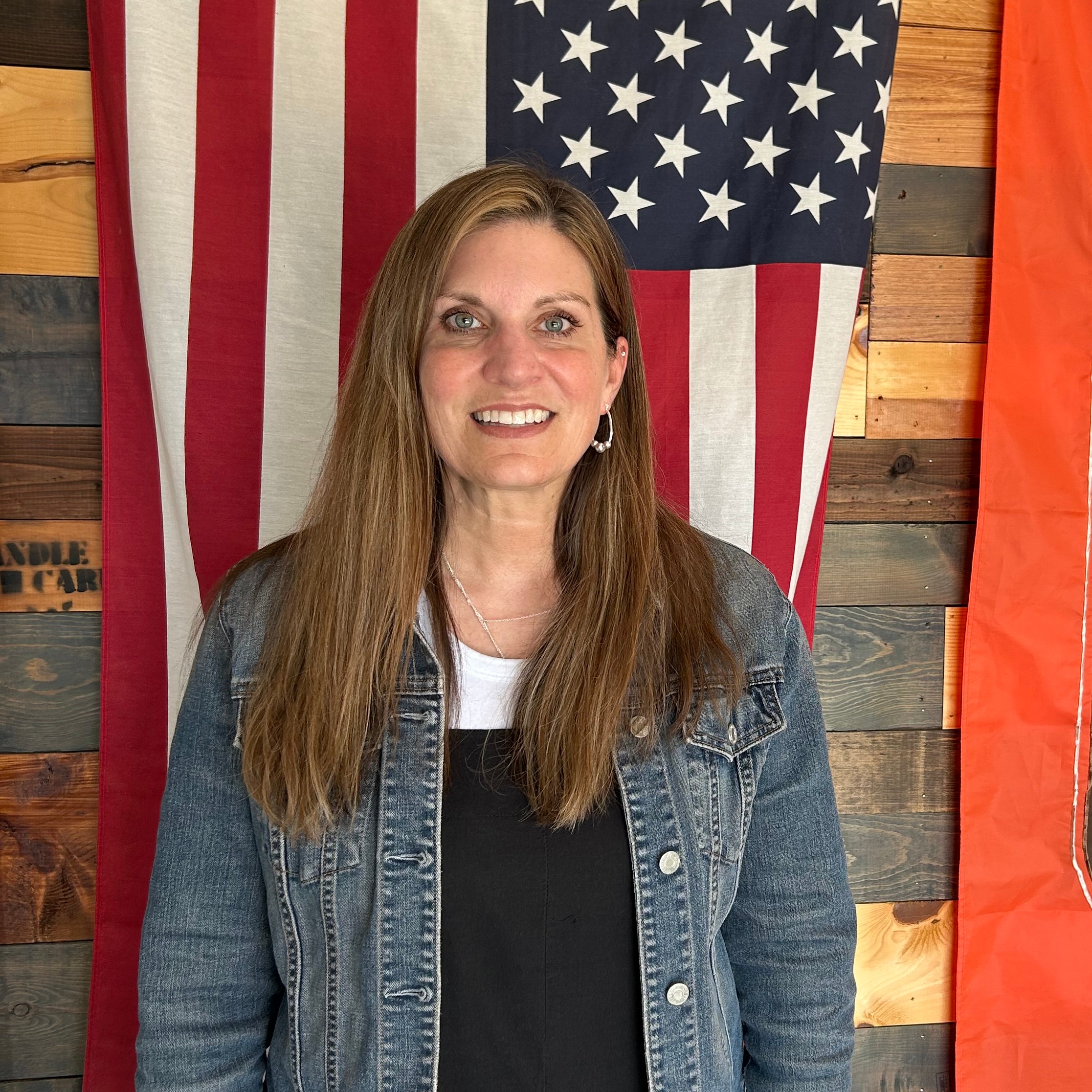teacher standing in front of flags