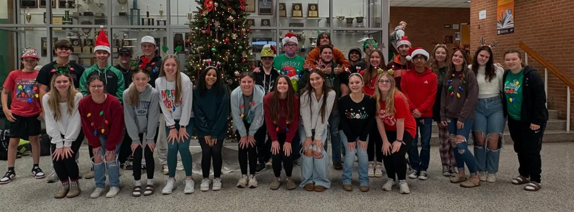 Students standing around a Christmas Tree