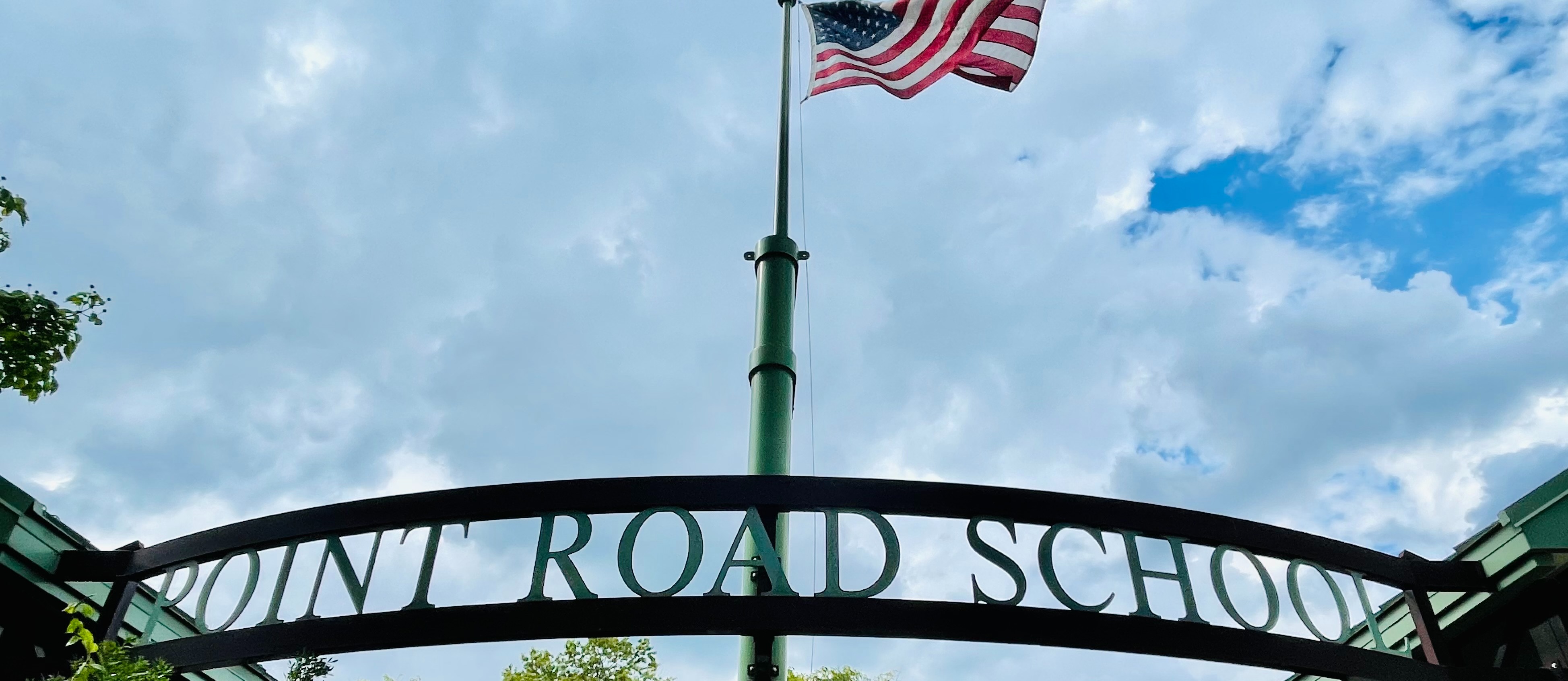 front of point road with flag and sign