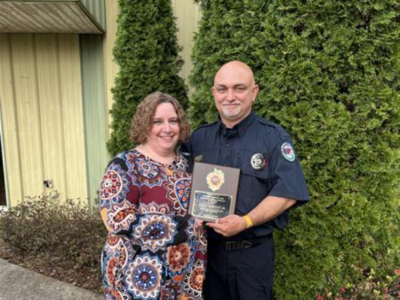 staff member that received a recognition plate