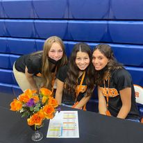 three girls waiting at student check in 
