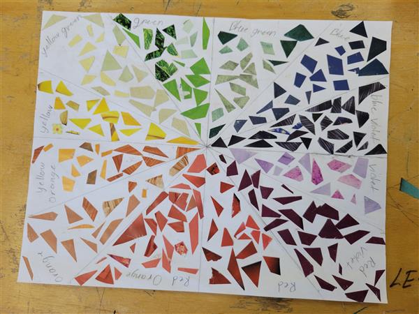 A colorful and vibrant mosaic art piece on a table.