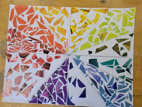A colorful and vibrant mosaic art piece on a table.