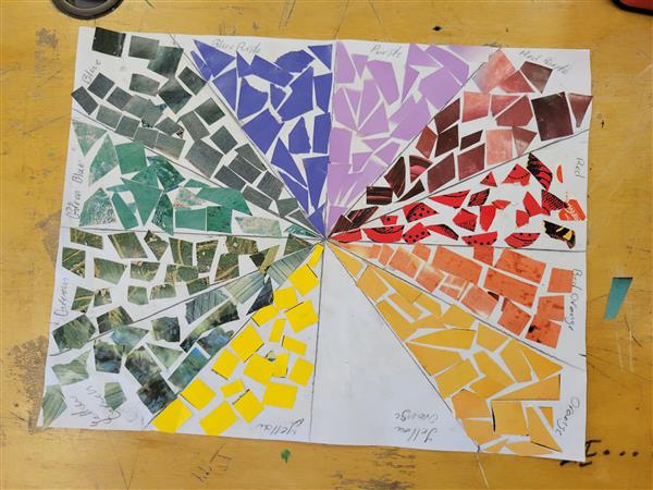 A colorful and vibrant mosaic art piece on a table.