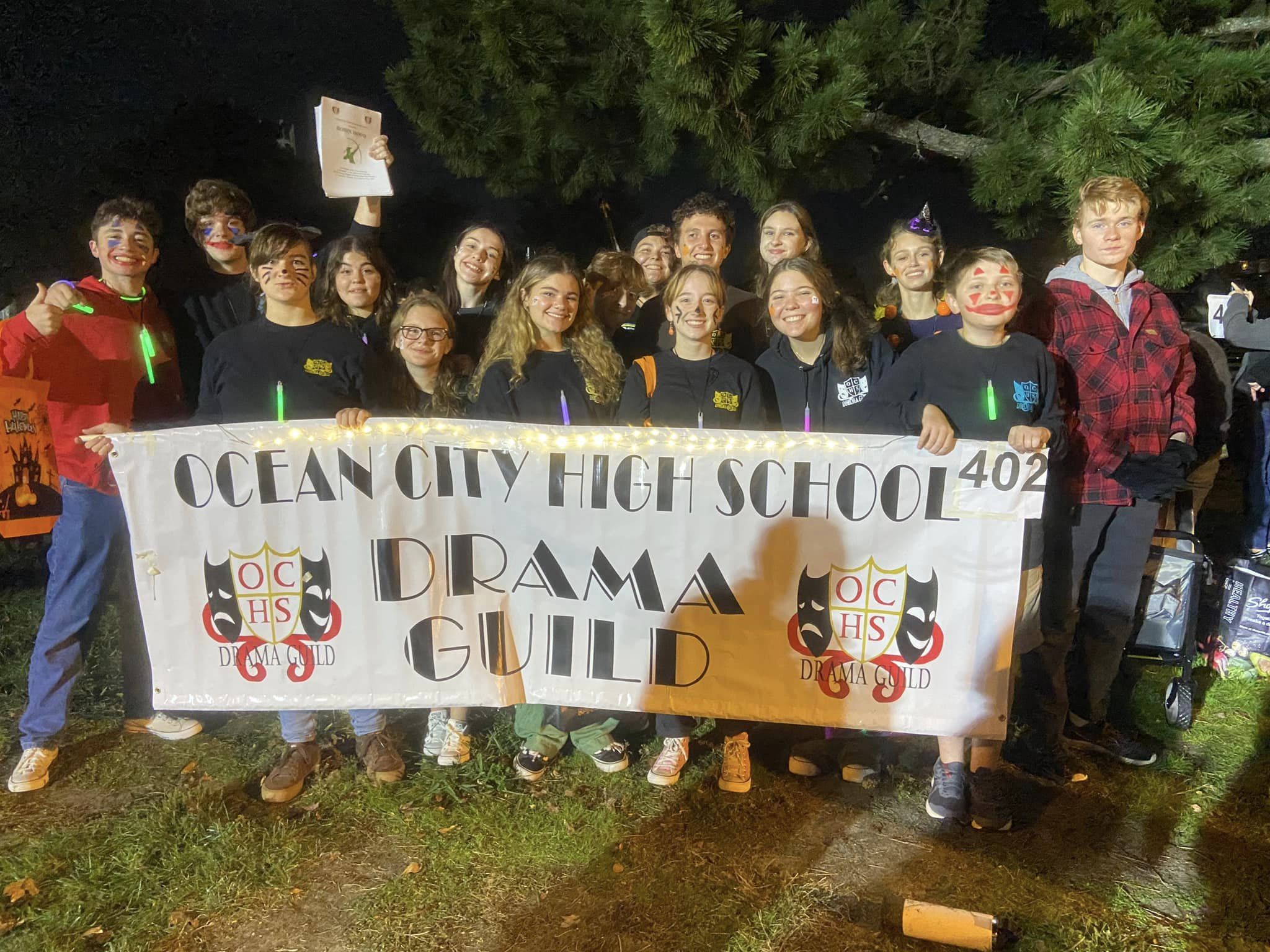 OCHS Students in the Drama Guild posing for a photo with a custom banner
