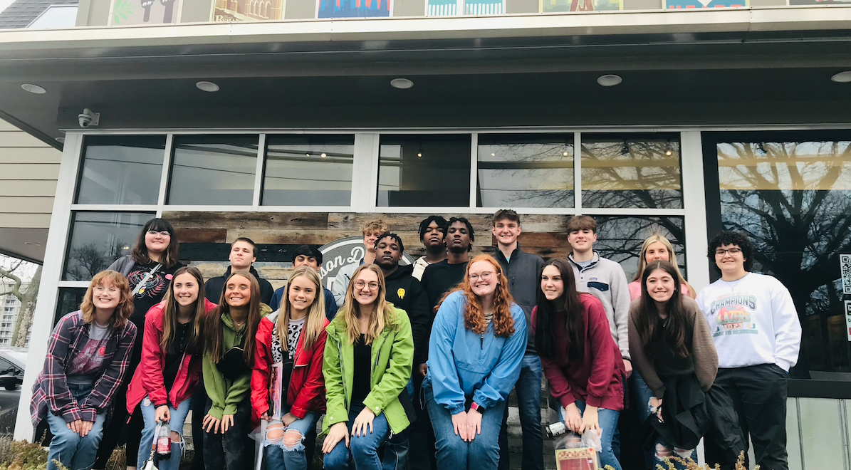 group of students together outside of a building