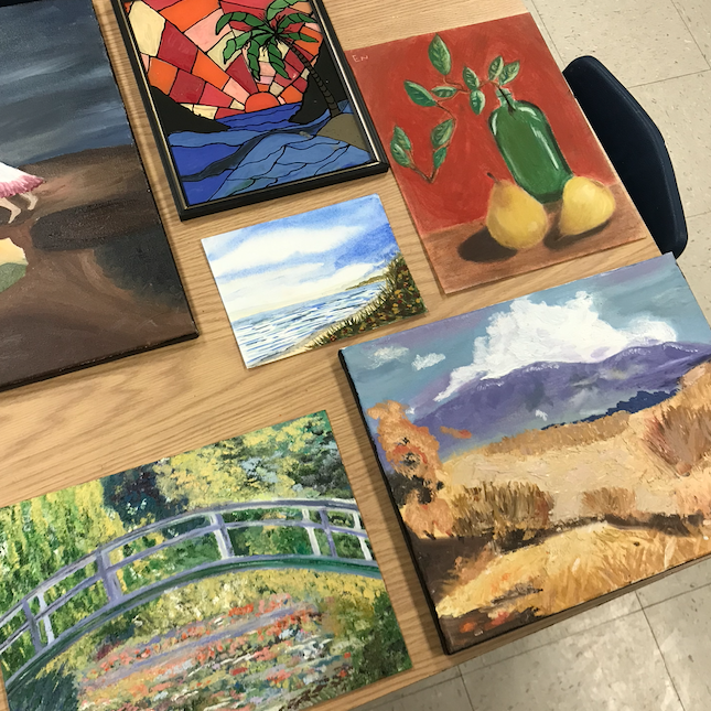 5 beautiful different paintings set on the table