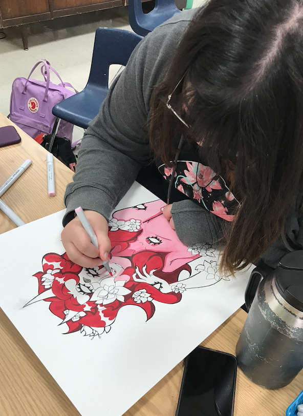 student adding color to a painting project