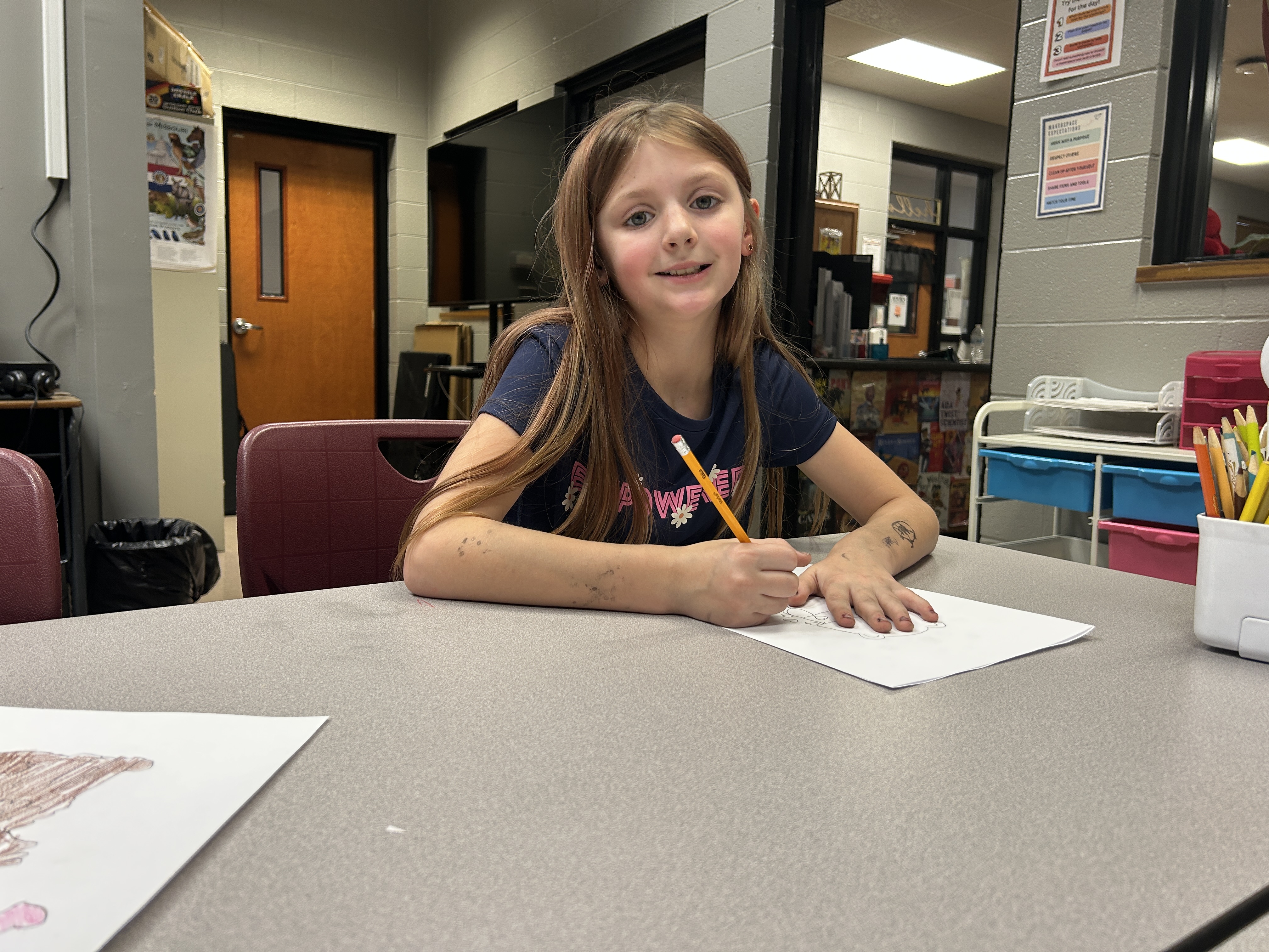 student writing at a desk
