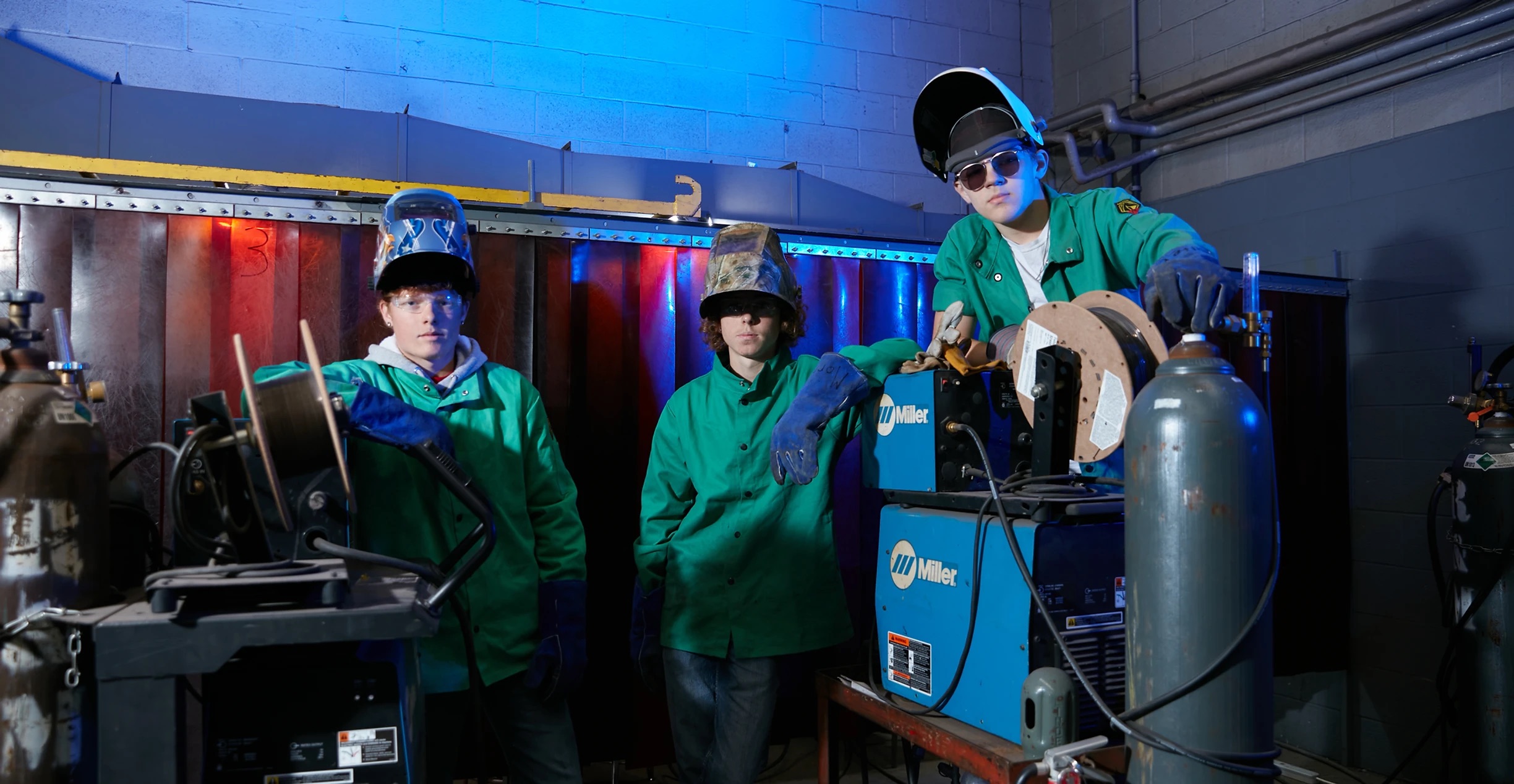 3 boys with welding equipment