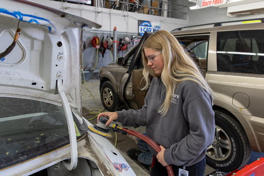 photo of student sanding car