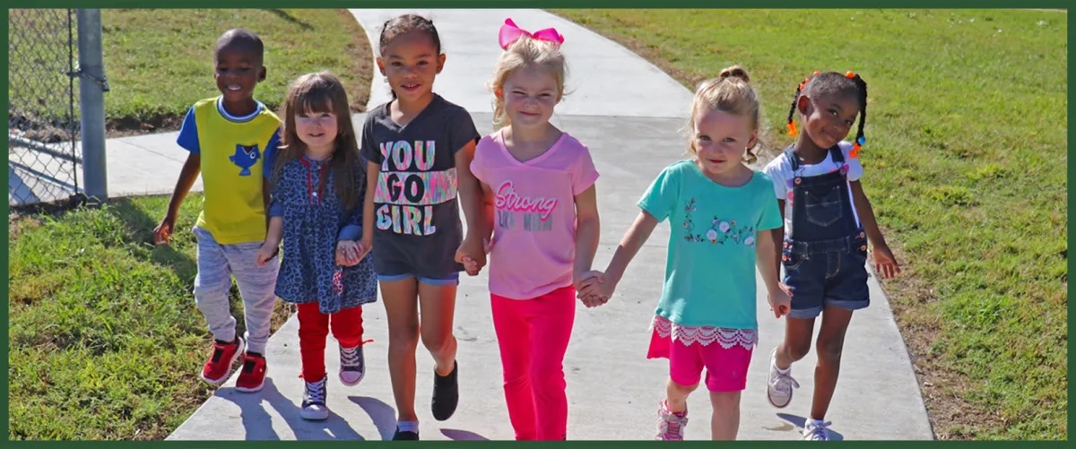 kids walking in the sidewalk 