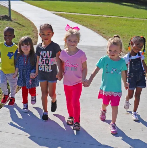 kids standing in the sidewalk 