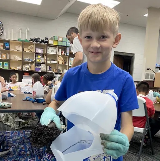 boy doing an class acyivity wearing globs 