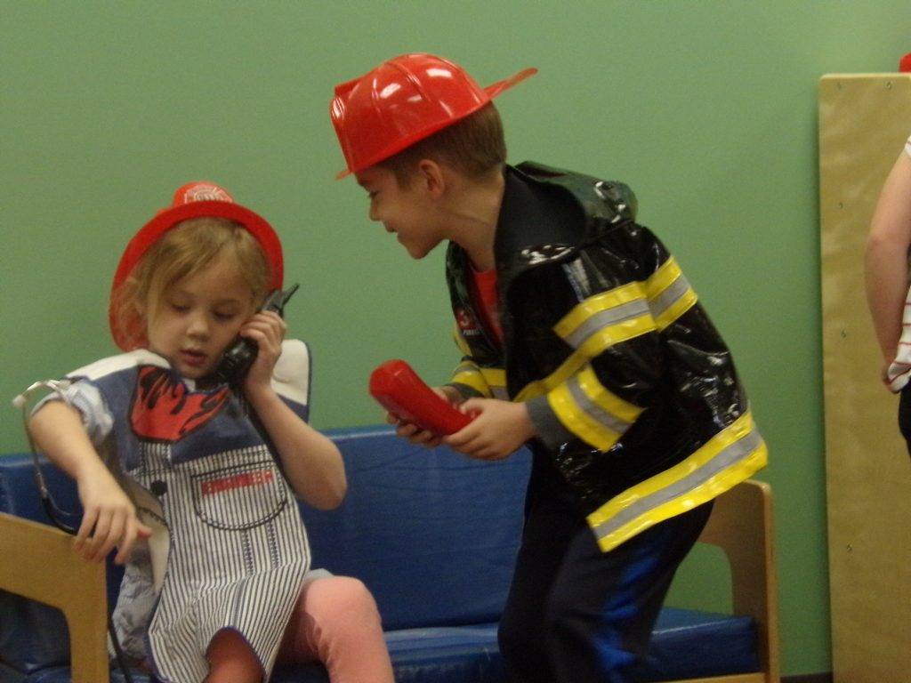 Two preeschool students dressed up as firefighters