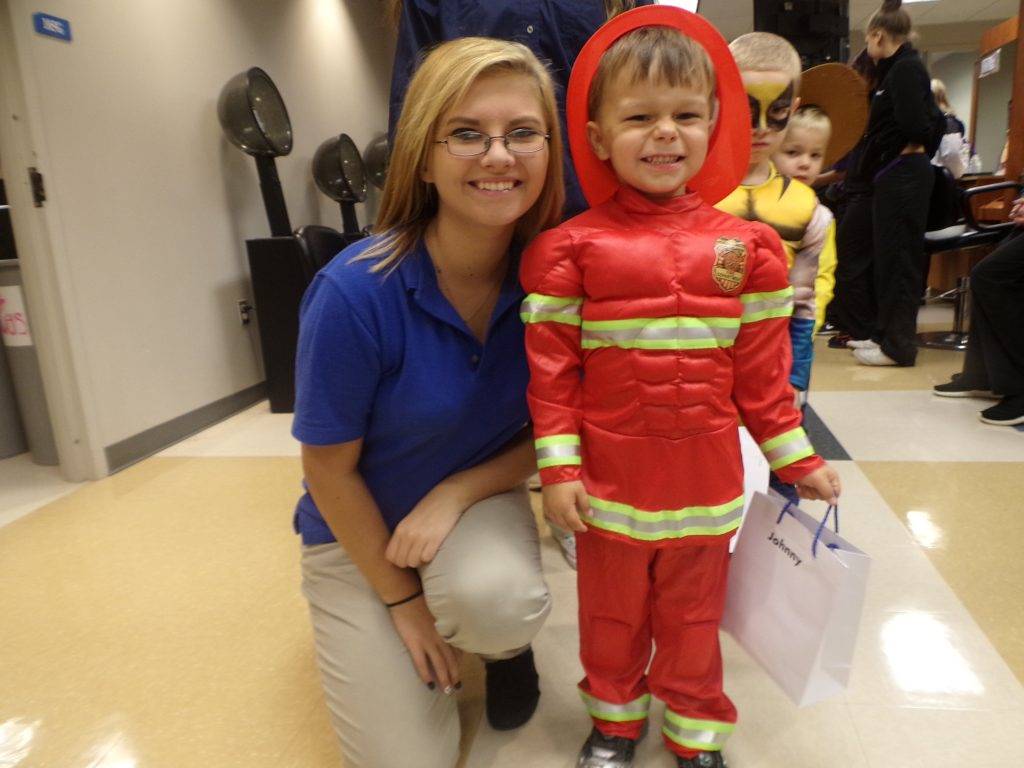 A teacher and a student dressed up as firefighter